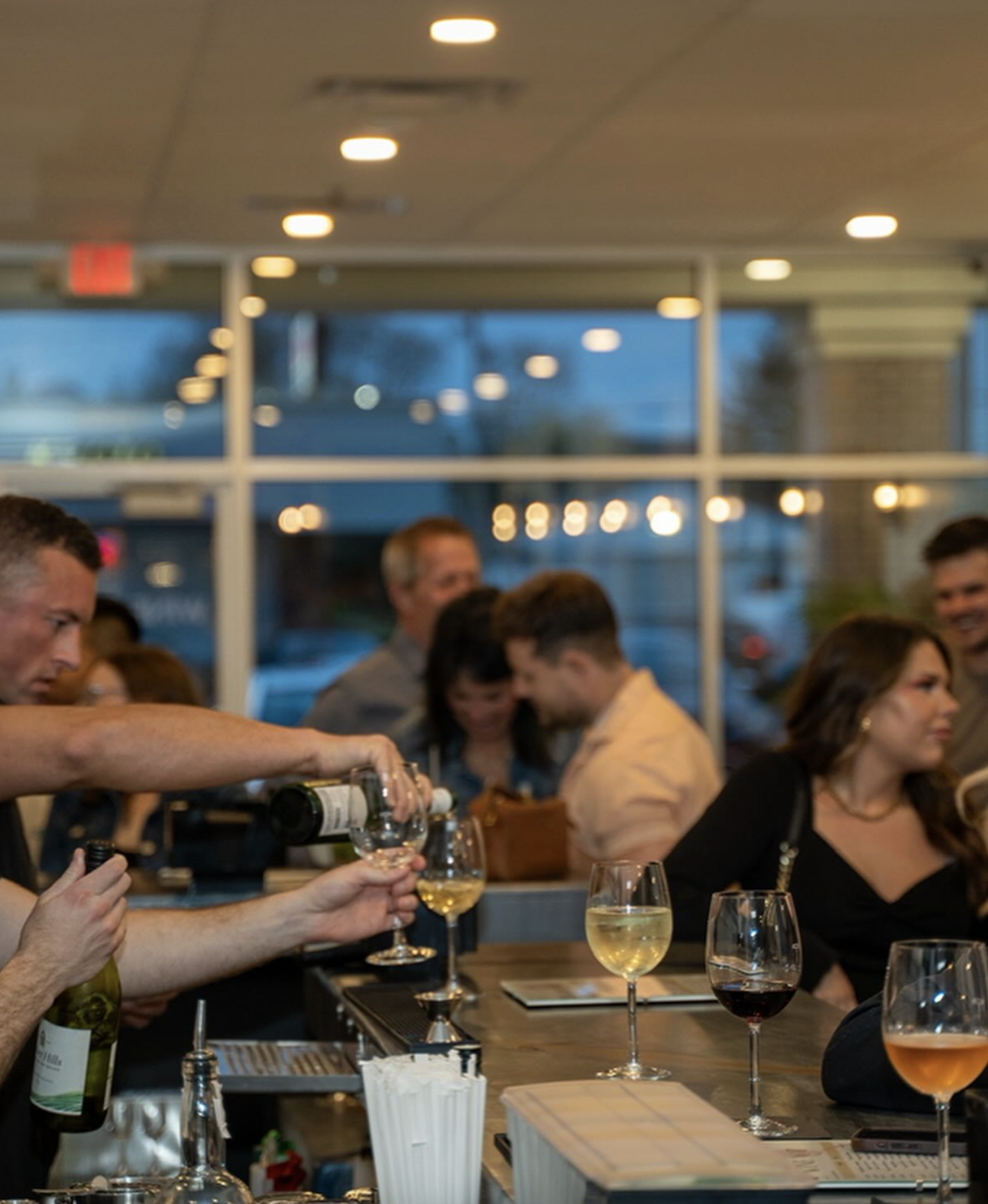 Bartender pouring wine on a busy Friday