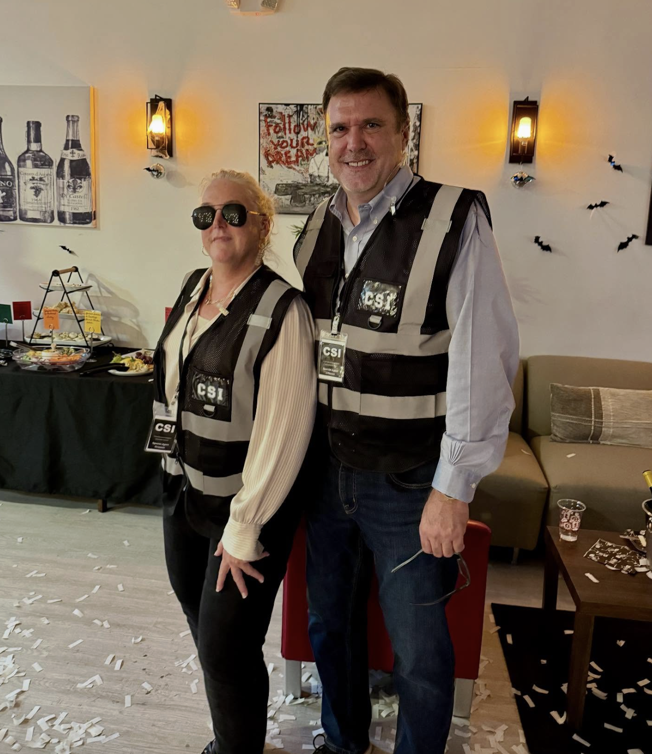 Two guests in CSI vests at the Hallowine costume party