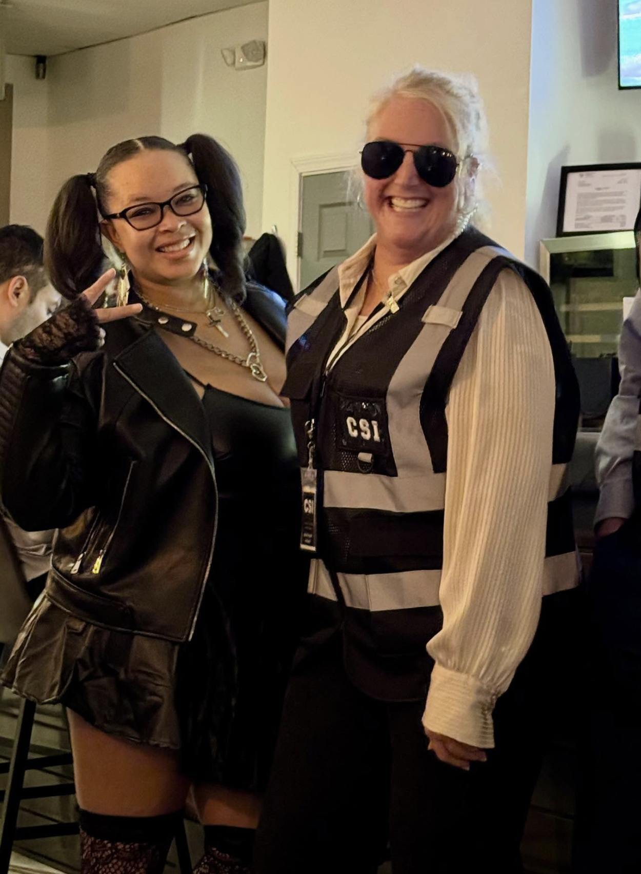 Friends in leather rocker outfit and CSI vest at the Hallowine costume party