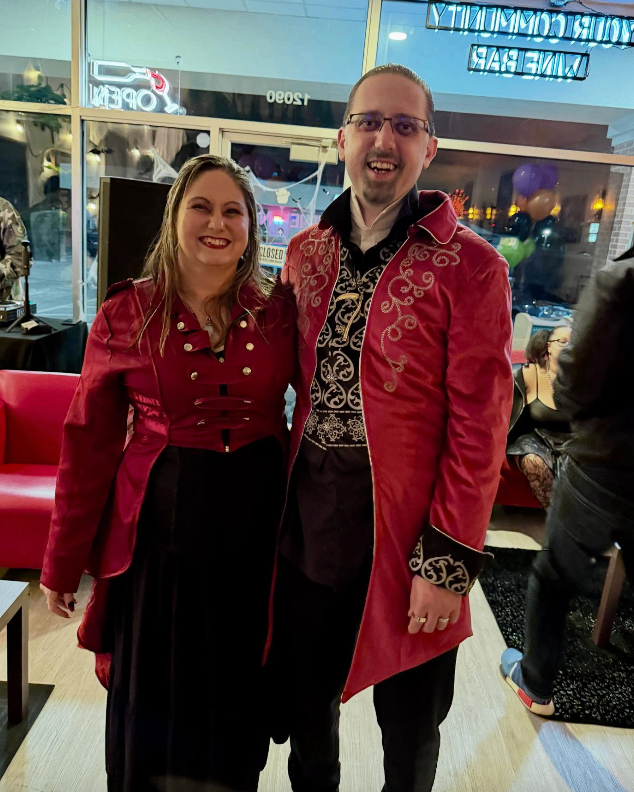 Couple in red and black vampire costumes outside the wine bar at Hallowine