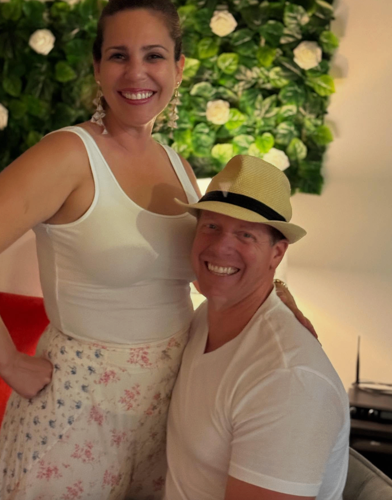 Couple in white outfits posing at the White Wine & Attire party